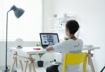 데스크 워커를 위한 실내 운동 추천 woman in white shirt sitting on chair using laptop computer