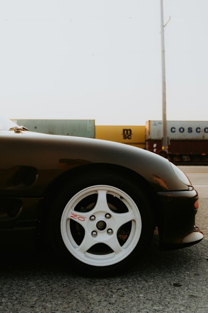 Photo by Luke Miller A black sports car parked on the side of the road