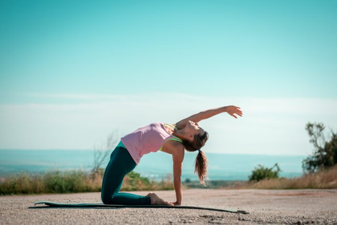 Photo by Stan Georgiev a woman doing a yoga pose on a yoga mat