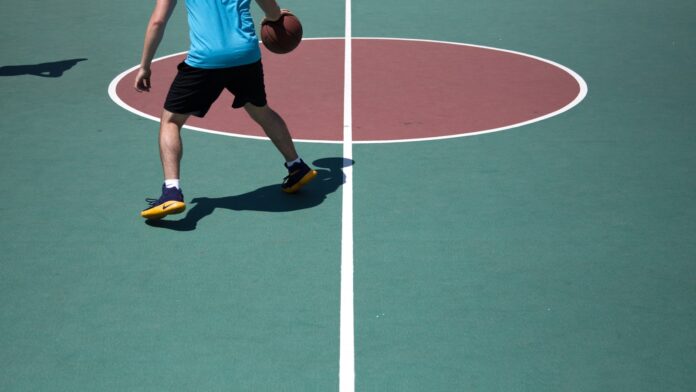 Photo by Filip Mroz man dribbling ball on court