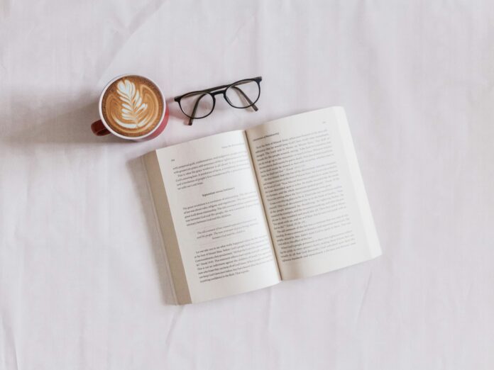 Photo by Sincerely Media book near eyeglasses and cappuccino